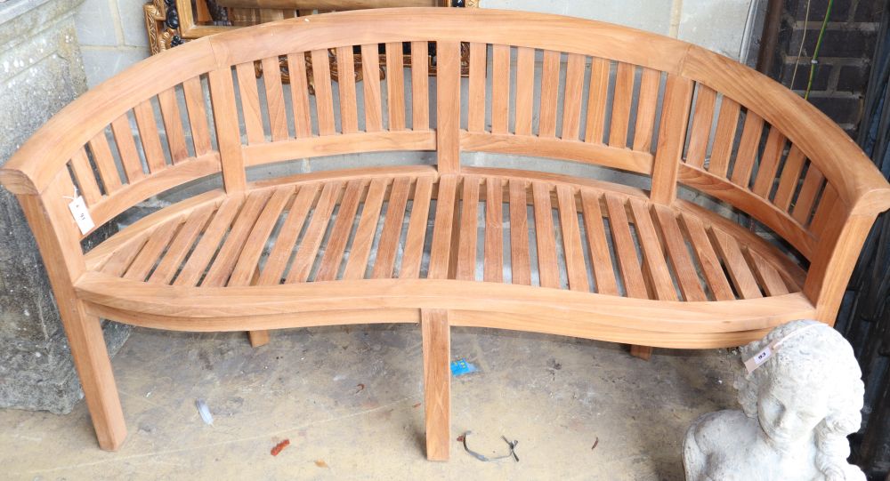 A teak banana garden bench, W.160cm, D.60cm, H.84cm, a.f.